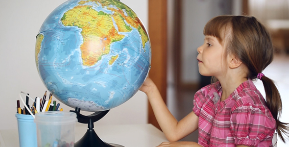 Little Girl Looking at Globe