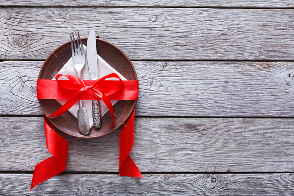 Valentine day background, cutlery on plate with ribbon on wood - Stock Photo - Images