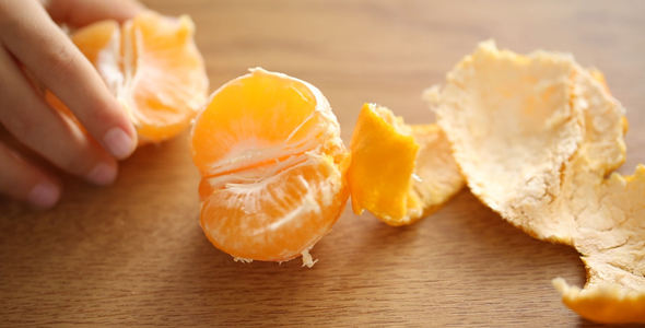 Little Girl Taking a Half of Tangerine