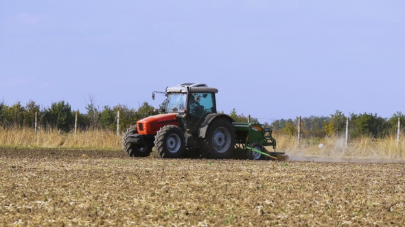 Red Tractor Mounted Seed Drill Plants the Seeds in the Soil in the Experimental Field alt