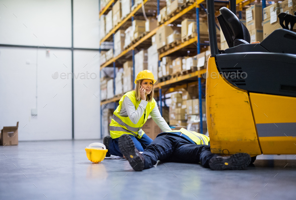 Warehouse workers after an accident in a warehouse. Stock Photo by halfpoint