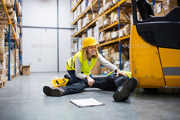 An injured worker after an accident in a warehouse. Stock Photo by halfpoint