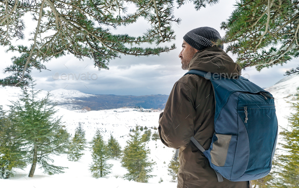 Traveler man in the snowy mountains - Stock Photo - Images