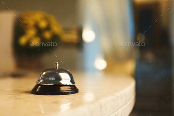 Hotel accommodation call bell on reception desk - Stock Photo - Images