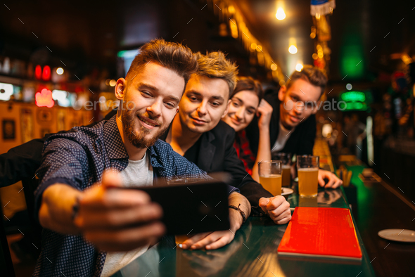 Happy football fans makes selfie at bar counter - Stock Photo - Images
