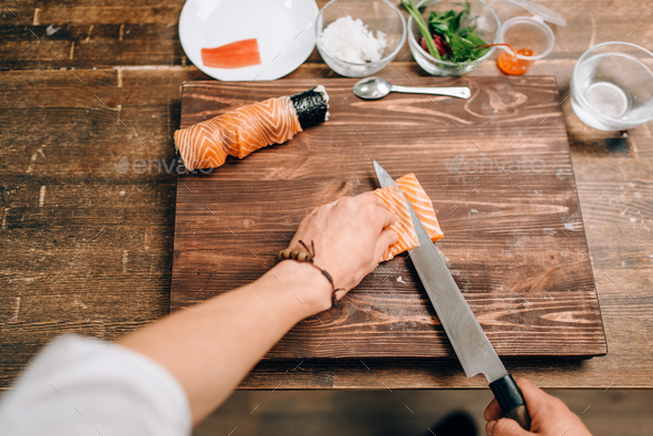 Male person cooking seafood, asian kitchen - Stock Photo - Images