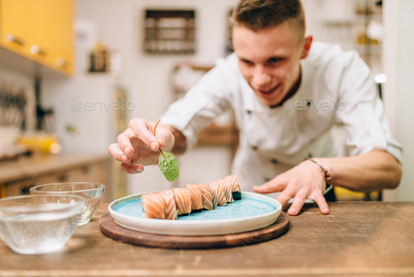 Man cooking sushi rolls, japanese kitchen Stock Photo by NomadSoul1