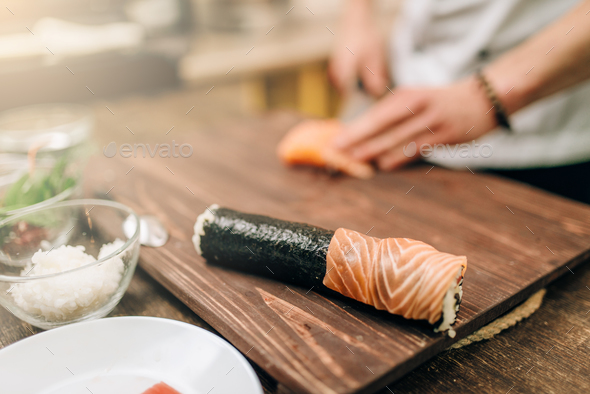 Male person cooking seafood, asian kitchen - Stock Photo - Images