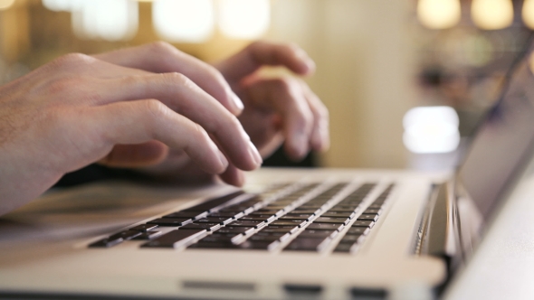 Businessman Typing His Fingers on the Laptop Keyboard Writes an E-mail To Team alt