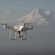 The Quadcopter Is Flying High Above Snowy Mountain - VideoHive Item for Sale