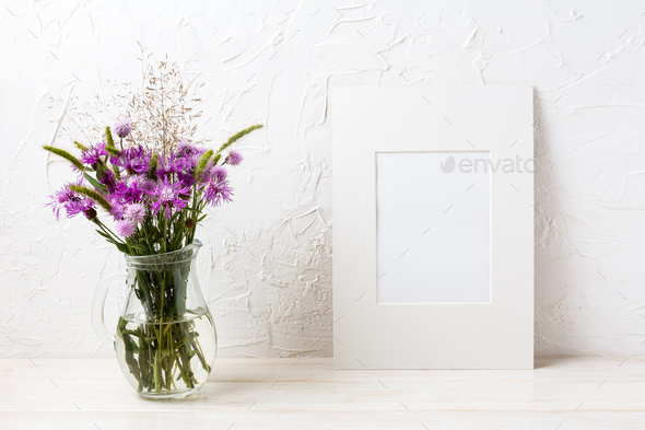 White frame mockup with purple burdock in the glass jug - Stock Photo - Images