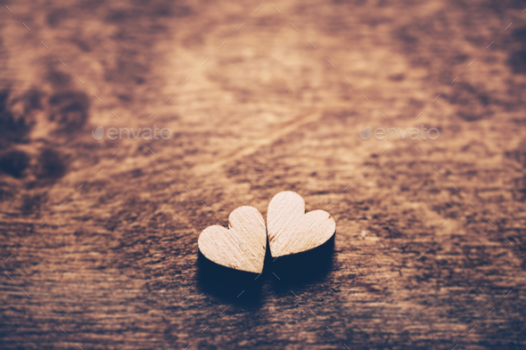 Two Wooden Hearts Placed On A Brown Wood Board. Stock Photo