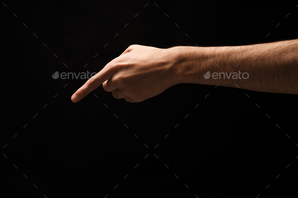 Hand gestures - man pointing, isolated at black - Stock Photo - Images