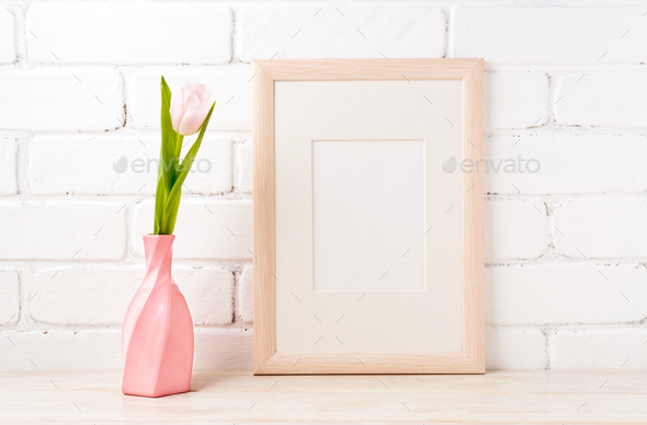 Wooden frame mockup with pink tulip in swirled vase - Stock Photo - Images