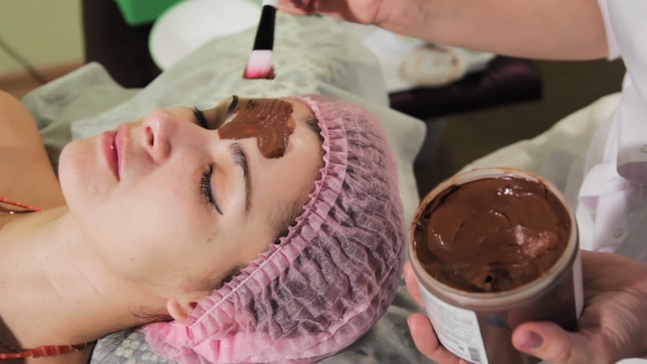 Young Beautiful Woman Having Spa Procedure on Her Face Chocolate Spa Chocolate Wrap