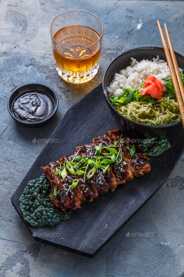 Asian style Barbecue pork ribs honey glazed on wooden board, top view