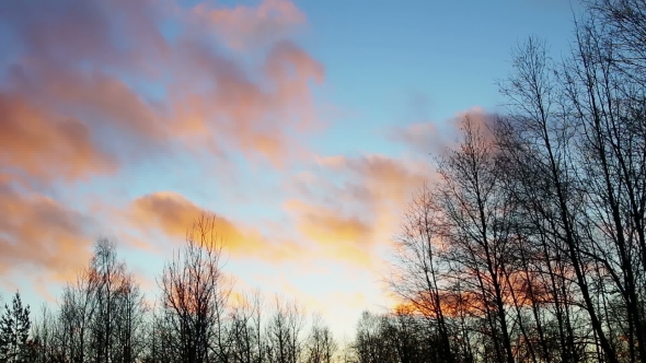 Clouds Run Through the Sky in Winter Sunset Landscape