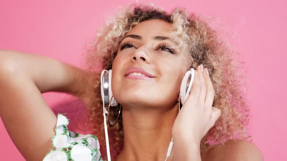 Girl smiling and listening to music in headphones