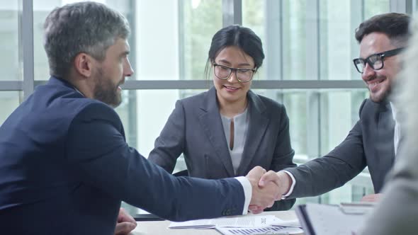 Business Partners Signing Contracts alt