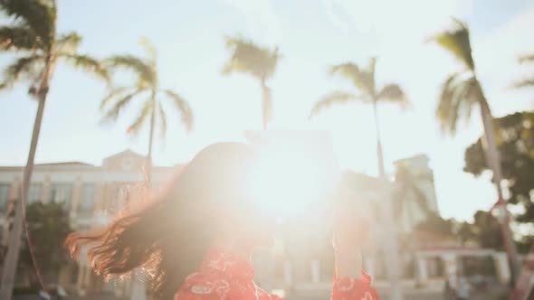 Vietnamese Girl Puts on a National Cap Non La in the Rays of the Evening Sunset alt