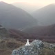 Bride in Wedding Dress Standing on a Cliff