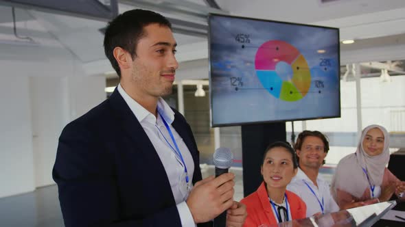 Male speaker at a business conference is applauded alt