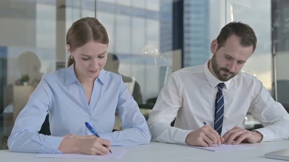 Executive Business People Writing Documents on Office Table alt