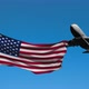 Commercial Plane Flies Over American Flag 