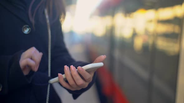 Woman Checking Destination Point on Phone and Entering Train, Online Ticket App alt