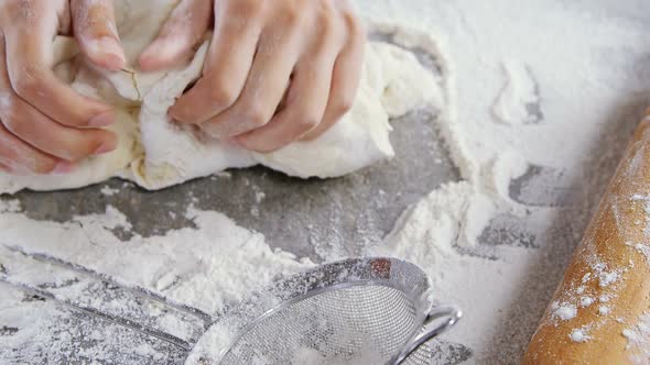 Woman kneading a dough alt