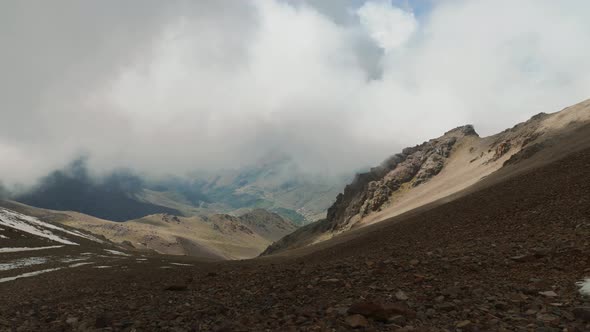 Heavy clouds slowly moving towards camera in High Atlas mountains, Morocco alt