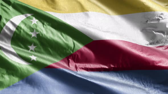 Comoros textile flag waving on the wind. Slow motion. 20 seconds loop.  alt
