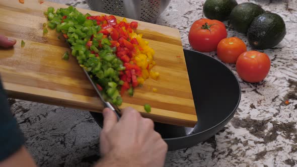Green Red And Yellow Peppers Diced And Put In Bowl