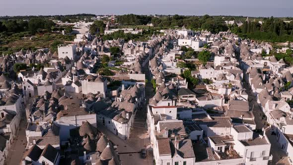 Aerial view of trulli of alberobello town in Italy. drone fly over old town buildings at sunrise