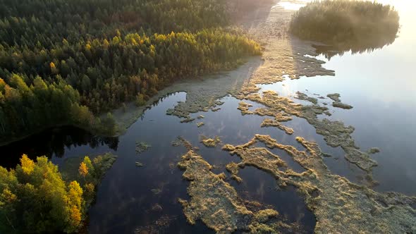 Aerial Shot of Foggy Lake with Islands Early in the Morning. Finland, Near Rovaniemi alt