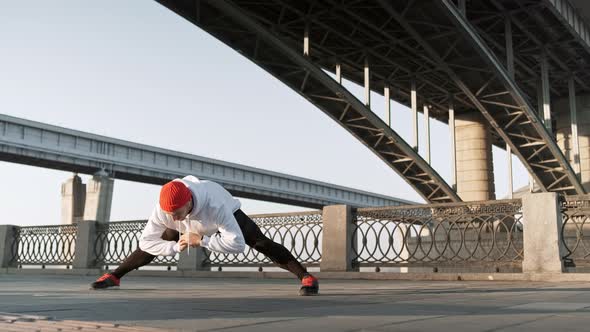 Exercising on Fresh Air. Confident Young Man Stretching His Body Before Running While Standing alt