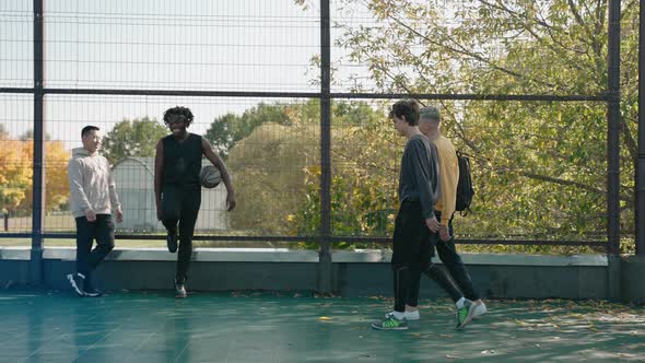 Guys Gather Together on a Court to Play Basketball on a Sunny Autumn Day