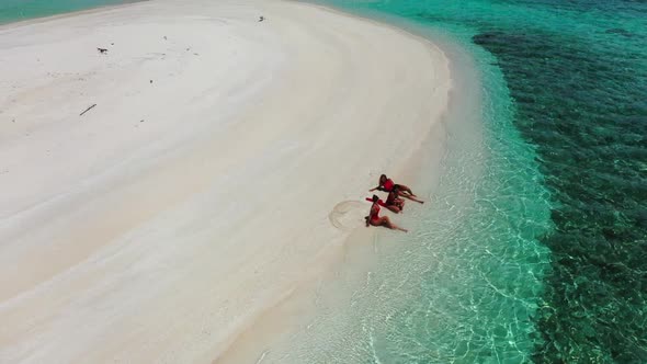 Ladies together tanning on marine coast beach time by blue water and white sand background of the Ma alt
