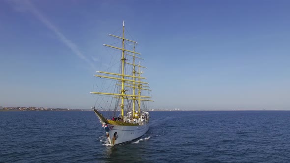 Romanian Navy training ship "Mircea" near the coastline on a sunny day in the Black Sea.