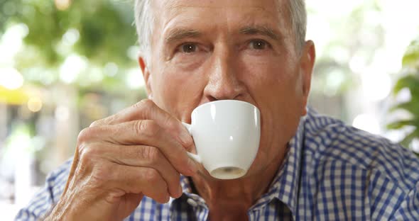 Senior Man Having Coffee in Cafe 4k alt