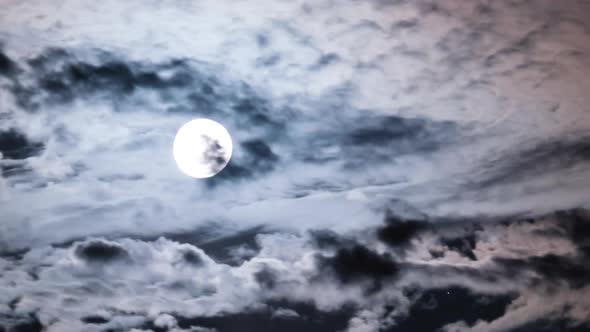 Full Moon Moves in the Night Sky Through Dark Clouds Timelapse alt