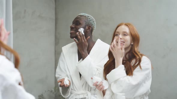 Young Interracial Multiethnic Diverse Man and Woman Spend Morning Routine in Bathroom Together