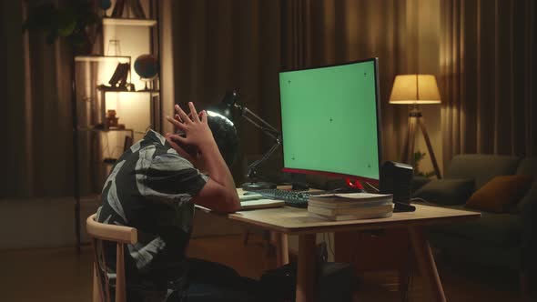 Teenage Boy Headache While Distance Learning With Mock Up Computer Green Screen From Home alt