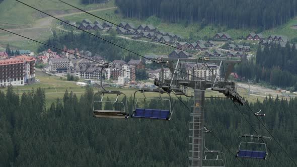 Chairlifts and houses in the mountains alt