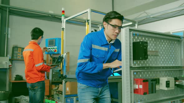 smart asian technical engineer working with assemble involved in the machine working design process