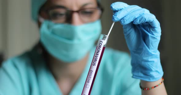 Doctor holding a coronavirus COVID-19 test tube