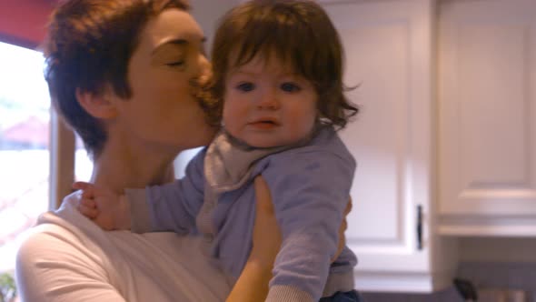 Mother kissing her baby alt