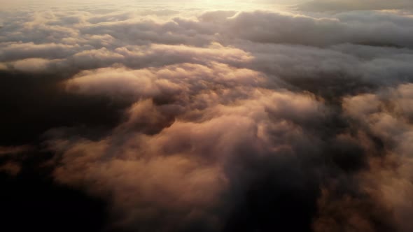 Aerial View Flying Over Clouds on Sun Rise in Mountains
