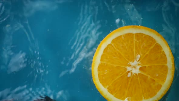 Sliced Orange Splashes in Water