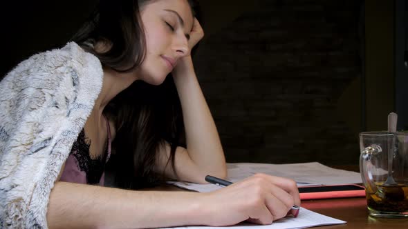 Sleepy Student Naps with Head on Hand Wakes and Writes alt